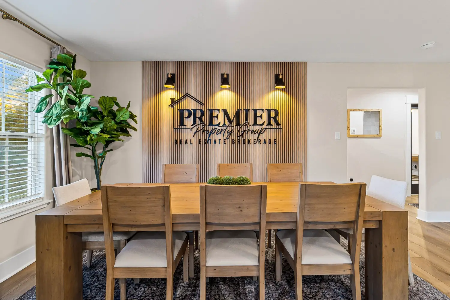 Premier Property Group office conference space and illuminated logo